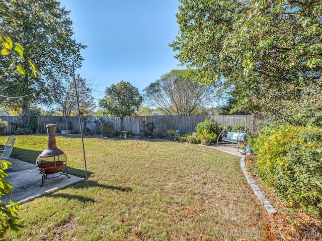 view of yard featuring a patio and a fire pit