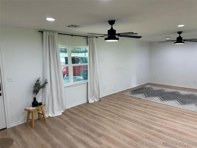 spare room featuring ceiling fan and light wood-type flooring