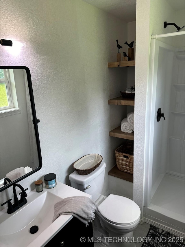 bathroom with vanity, toilet, and walk in shower