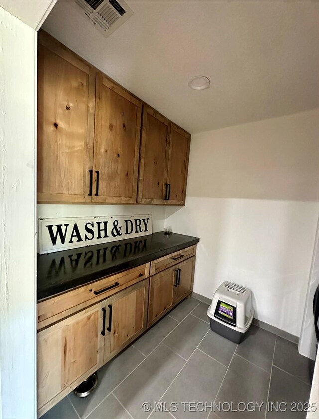 kitchen with dark tile patterned floors