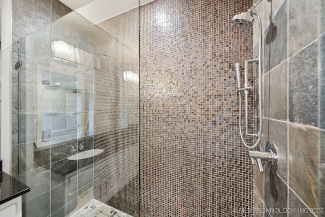 bathroom featuring a stall shower and vanity