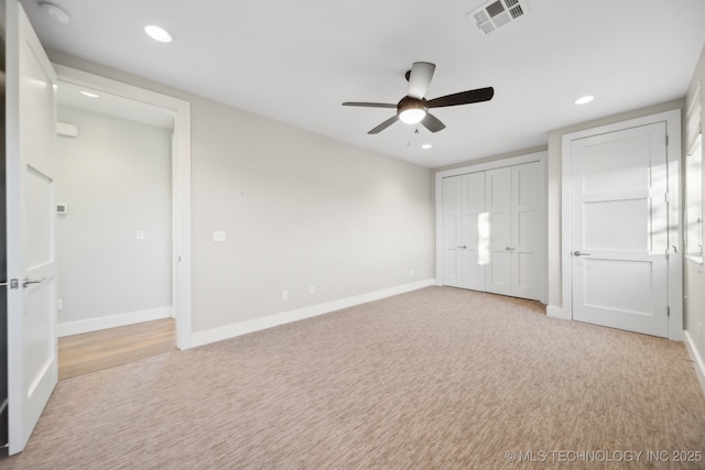 unfurnished bedroom featuring ceiling fan and light carpet