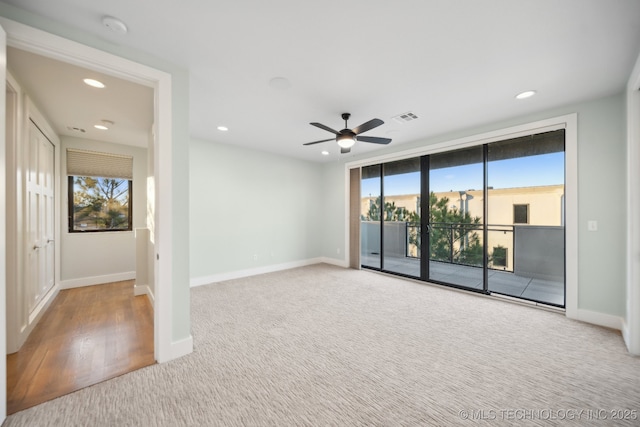 carpeted empty room featuring ceiling fan