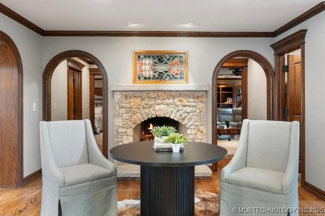 sitting room featuring ornamental molding, hardwood / wood-style floors, and a fireplace