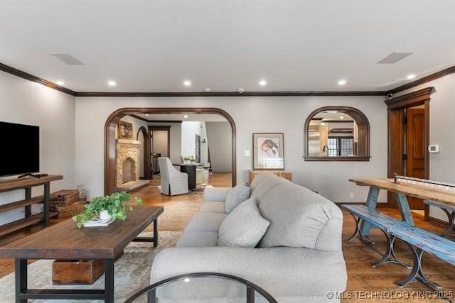 living room featuring hardwood / wood-style flooring and ornamental molding