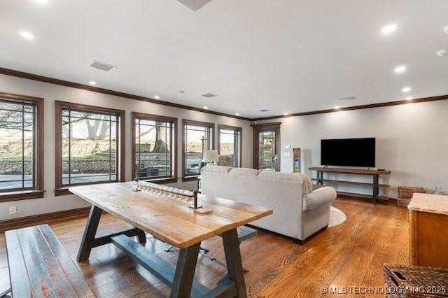 living room with ornamental molding and hardwood / wood-style floors