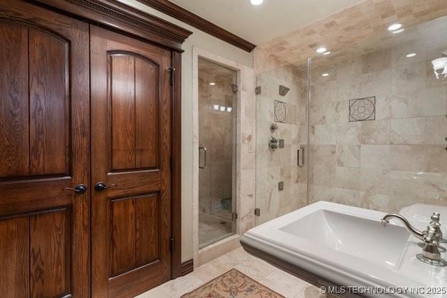 bathroom with tile walls, crown molding, and walk in shower