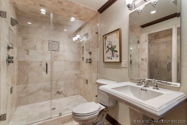 bathroom with crown molding, toilet, and a shower with door