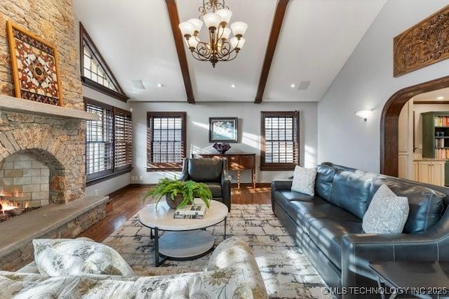 living room featuring beam ceiling, high vaulted ceiling, hardwood / wood-style floors, and a fireplace