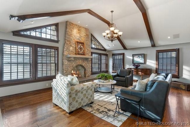 living room featuring beamed ceiling, a fireplace, dark hardwood / wood-style floors, and a healthy amount of sunlight