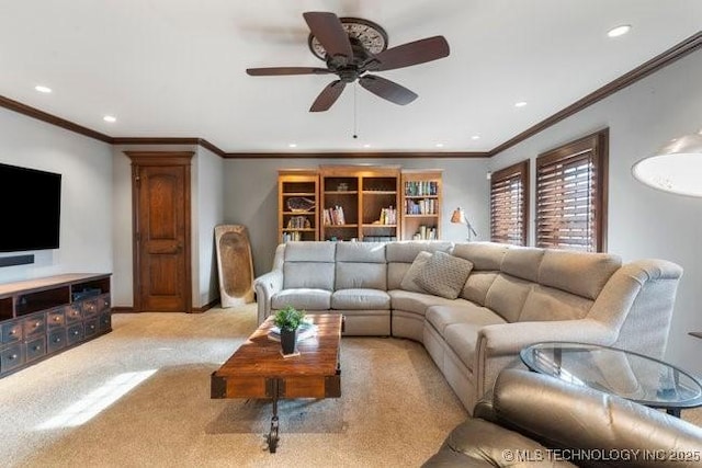 carpeted living room with crown molding and ceiling fan