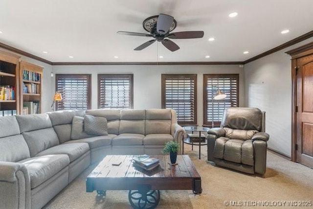 living room with crown molding, a healthy amount of sunlight, light carpet, and ceiling fan