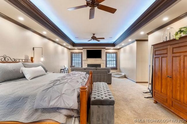 carpeted bedroom with a raised ceiling and crown molding