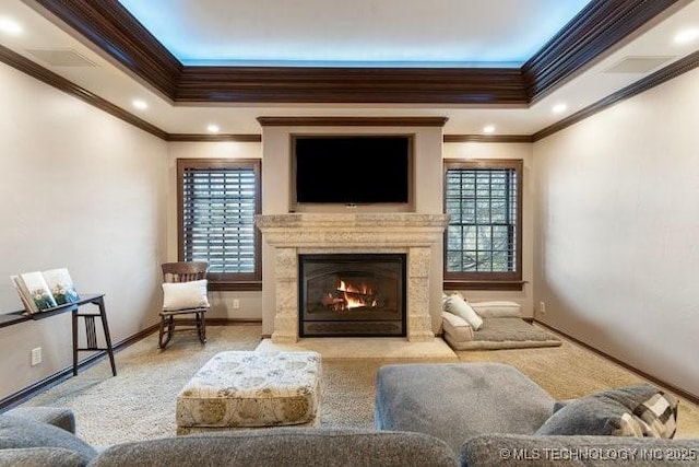 living room with light colored carpet, a tray ceiling, and a premium fireplace