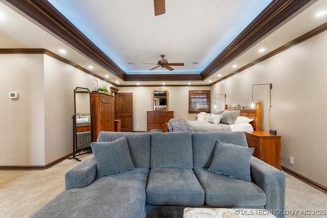 carpeted living room with ceiling fan and a raised ceiling