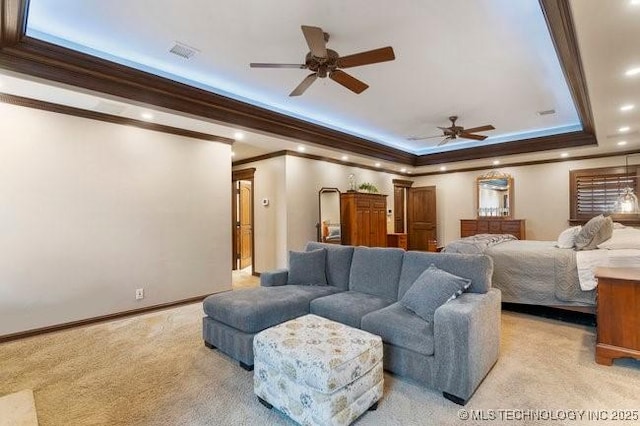 bedroom with light carpet, a tray ceiling, and ornamental molding