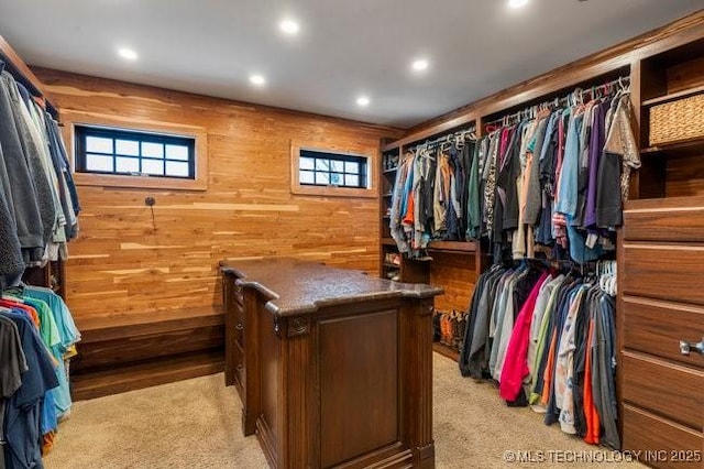 walk in closet with light carpet