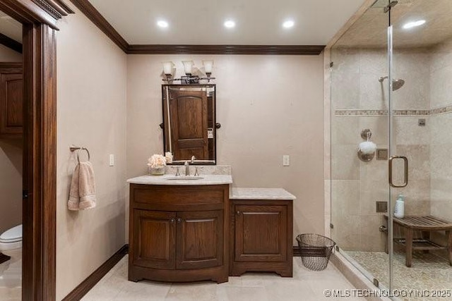 bathroom featuring crown molding, vanity, toilet, and a shower with shower door