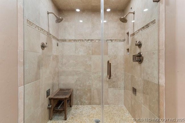 bathroom with a shower with door