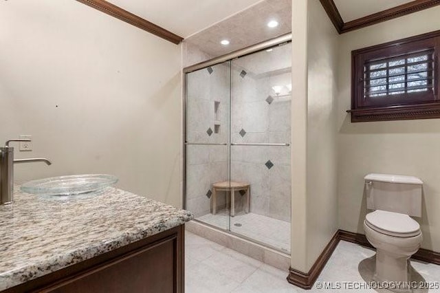 bathroom with vanity, crown molding, a shower with shower door, and toilet