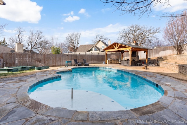 view of pool featuring a gazebo, outdoor lounge area, exterior kitchen, and a patio