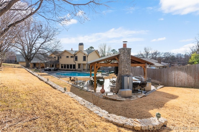 back of house with a gazebo, a yard, and a fenced in pool