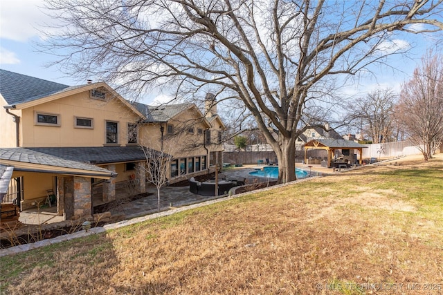 view of yard featuring a fenced in pool, a gazebo, and a patio area