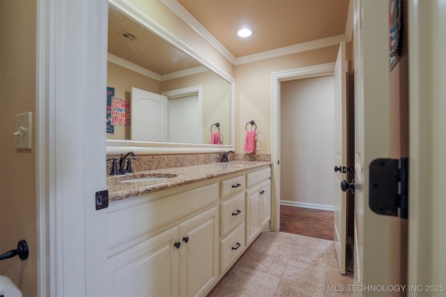 bathroom featuring tile patterned flooring, crown molding, and vanity