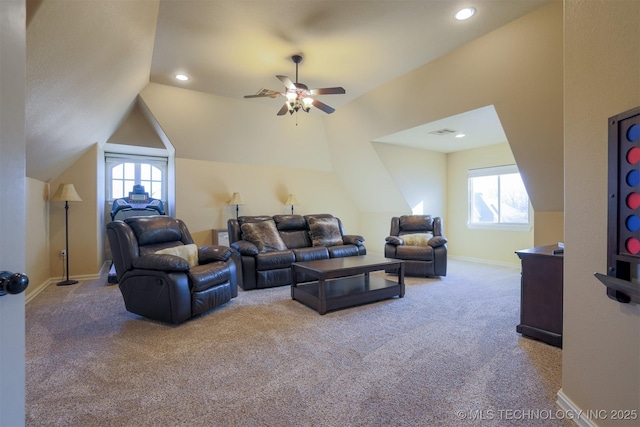 carpeted living room with ceiling fan and vaulted ceiling