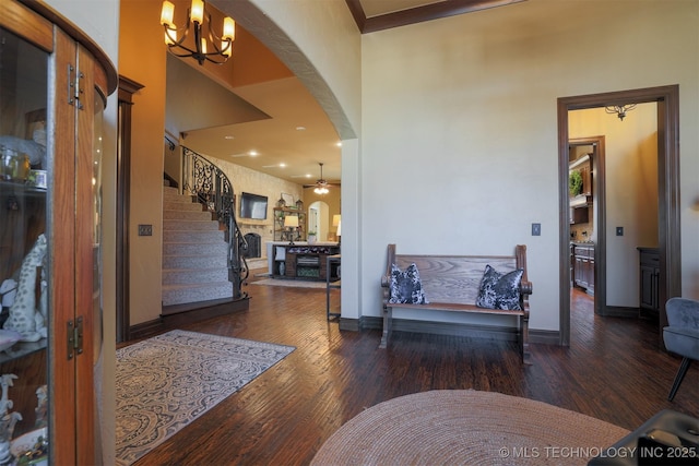 entrance foyer with ceiling fan with notable chandelier and hardwood / wood-style floors