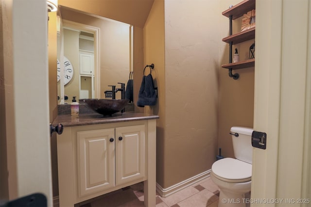 bathroom featuring vanity, toilet, and tile patterned flooring