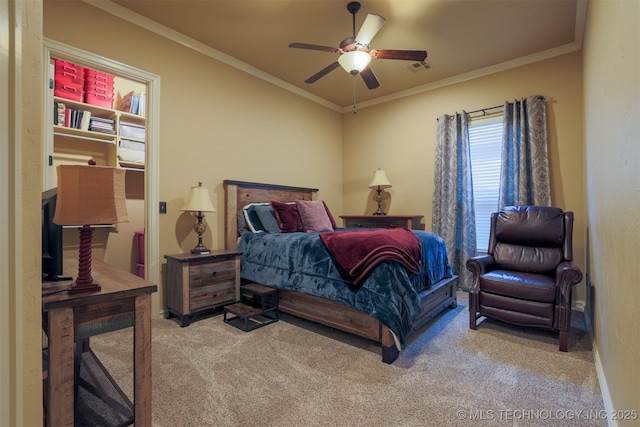 bedroom with ceiling fan, ornamental molding, and carpet floors