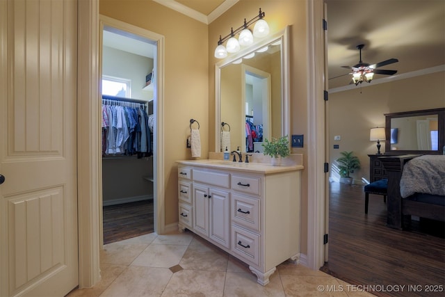 bathroom with ornamental molding, tile patterned floors, ceiling fan, and vanity