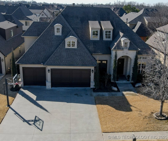 french country style house with a garage