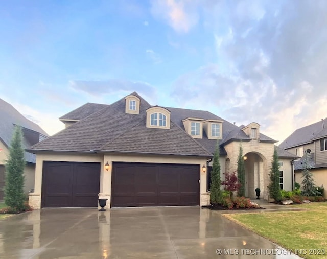 french country home featuring a garage