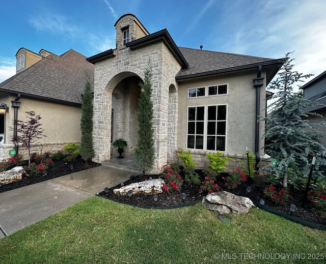 french provincial home featuring a front lawn