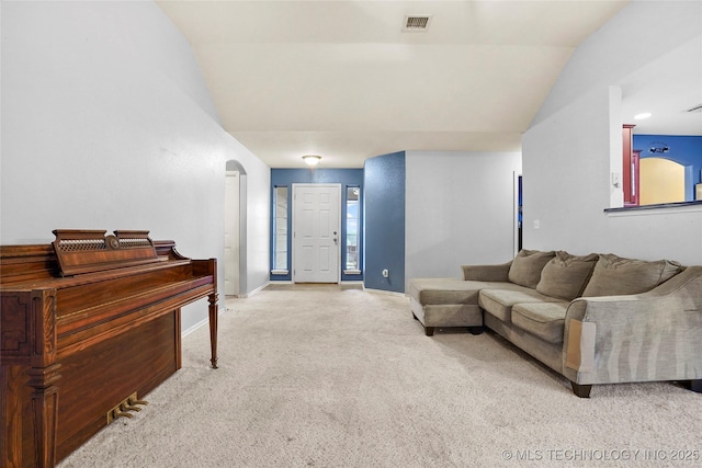 carpeted living room featuring lofted ceiling