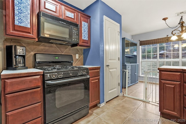 kitchen featuring light tile patterned floors, decorative backsplash, and black appliances