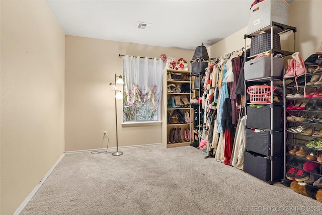 walk in closet with carpet flooring