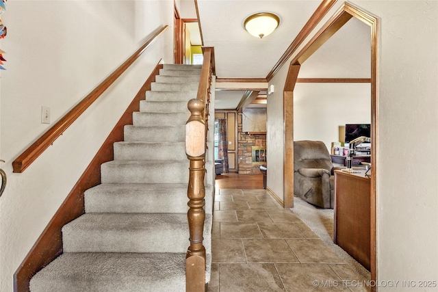 staircase featuring crown molding