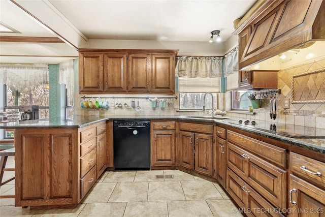 kitchen with sink, premium range hood, black appliances, kitchen peninsula, and dark stone counters