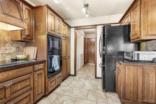 kitchen with custom exhaust hood, black appliances, dark stone countertops, light tile patterned floors, and backsplash