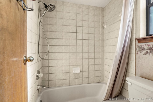 bathroom with shower / tub combo and toilet