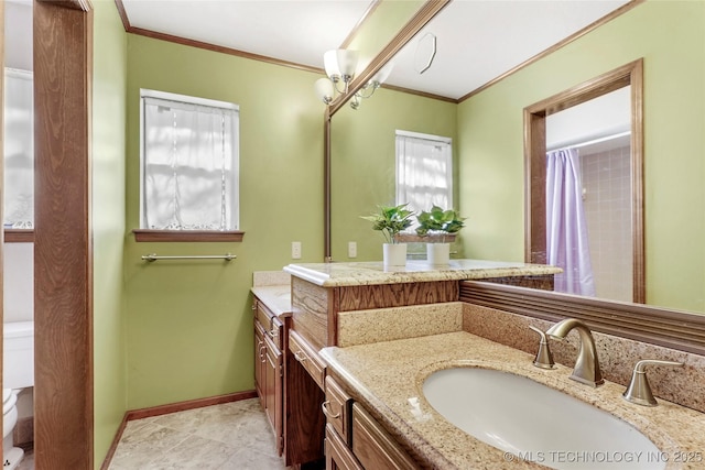 bathroom featuring vanity, ornamental molding, and toilet