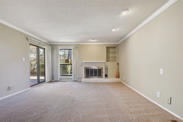 unfurnished living room featuring a tiled fireplace, crown molding, light colored carpet, and built in features