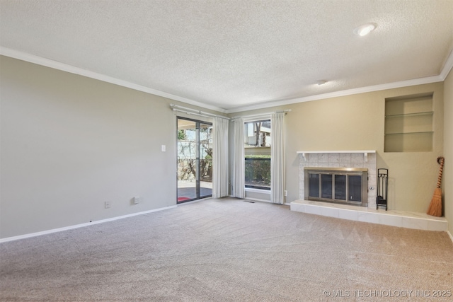 unfurnished living room featuring ornamental molding, carpet, and a textured ceiling