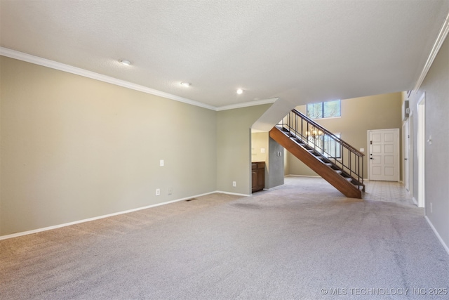 unfurnished living room featuring light colored carpet, ornamental molding, and a textured ceiling