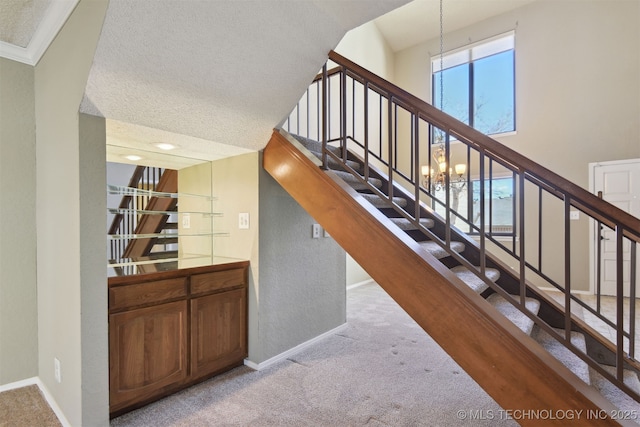 stairs featuring a towering ceiling, a chandelier, and carpet