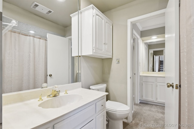 bathroom featuring vanity and toilet