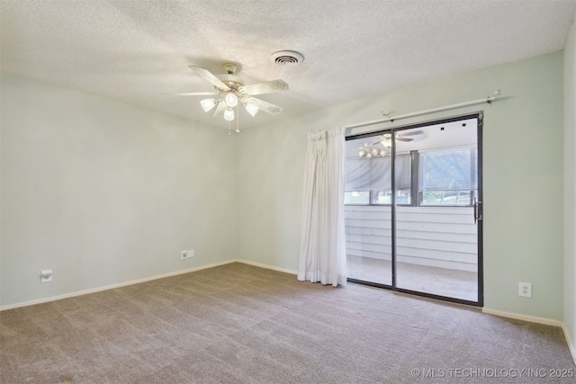 empty room featuring ceiling fan, carpet flooring, and a textured ceiling